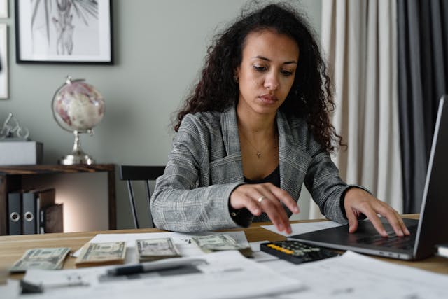 A financial expert using a calculator at their desk