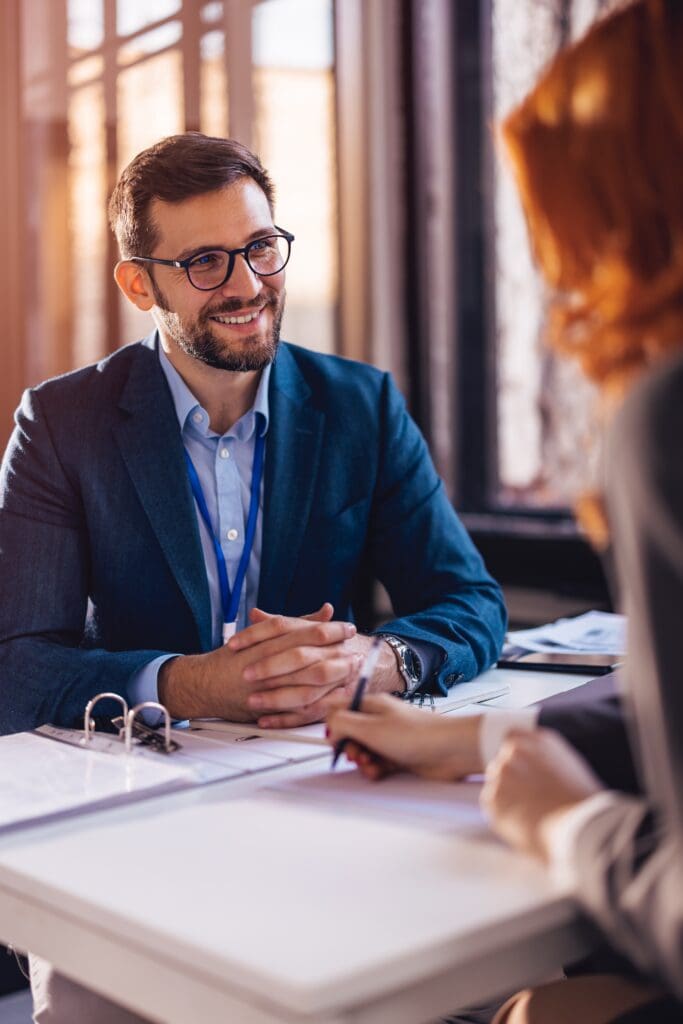 Property manager sitting down with a client to sign papers