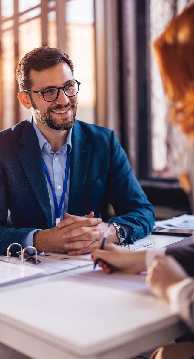 The,Real,Estate,Agent,Closes,The,Deal,With,The,Client Property manager sitting down with a client to sign papers