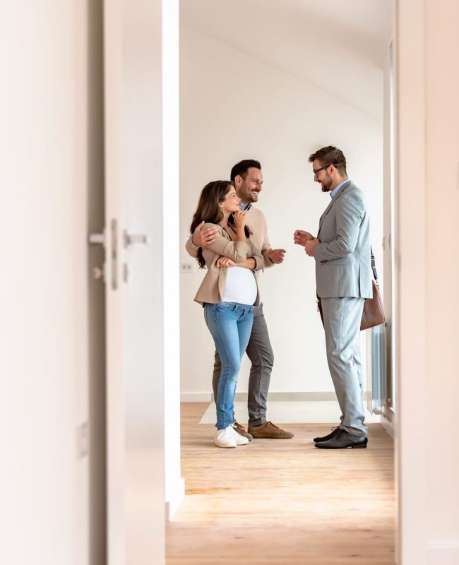 Young couple signing papers on a property