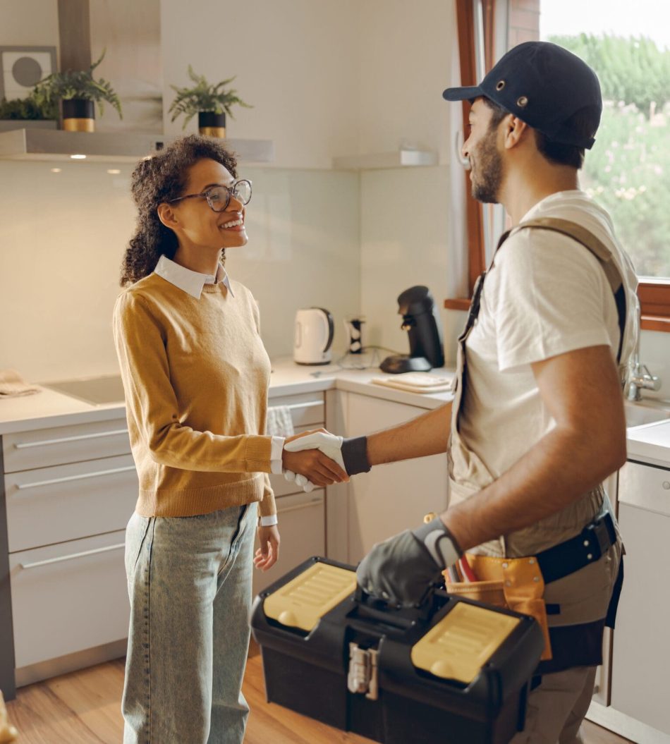 Professional,Repairman,In,Uniform,Shaking,Hands,With,Woman,While,Standing guy at home for repairs