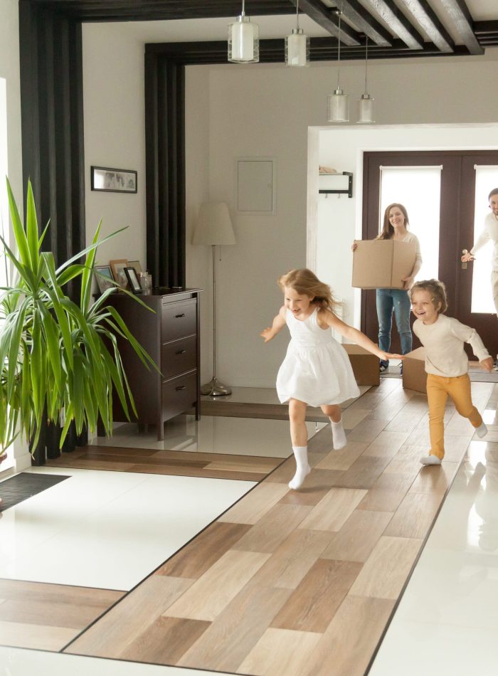 Playful,Happy,Kids,Running,Into,New,Big,Own,Beautiful,House, Happy rental tenants moving in with kids playing