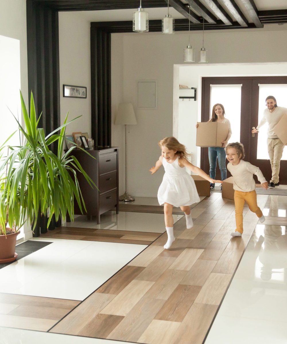 Happy rental tenants moving in with kids playing