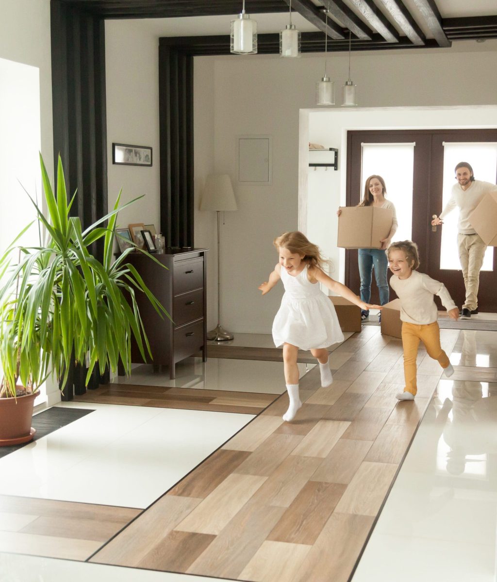 Playful,Happy,Kids,Running,Into,New,Big,Own,Beautiful,House, Happy rental tenants moving in with kids playing